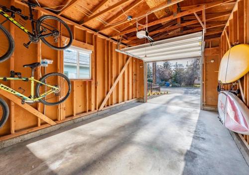 a bike hanging on the wall of a garage at Mid Century Modern Boise-River Bungalow w/ Hot Tub in Boise