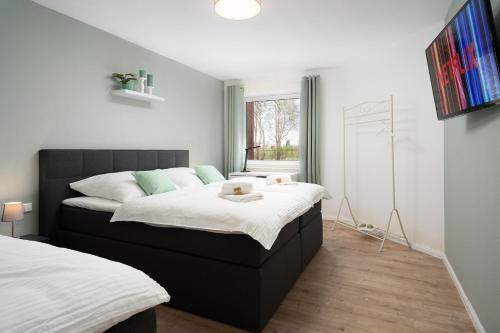 1 Schlafzimmer mit 2 Betten und einem Fenster in der Unterkunft Aparte - Washer & Dryer - Kitchen & Parking - Smart-TV in Sarstedt