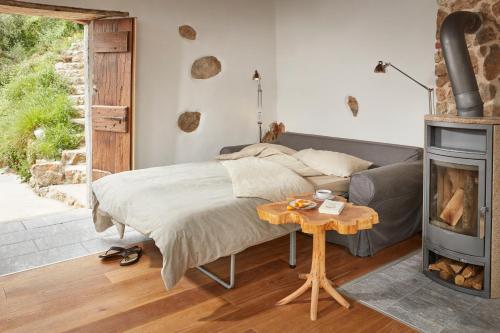 a bedroom with a bed and a fireplace at Casa Berti - Urlaub im Olivenhain in Camaiore
