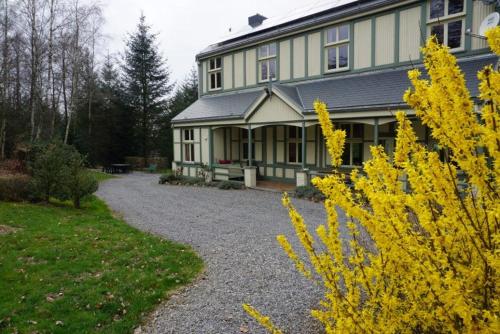 a large house with a gravel driveway in front of it at Le Chaumont in Theux