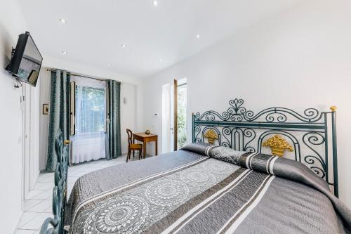 een slaapkamer met een bed en een tv. bij Gelsomino Rooms Ravello in Ravello