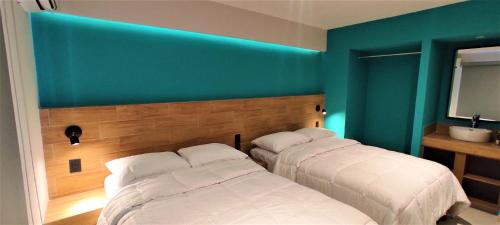 Ένα ή περισσότερα κρεβάτια σε δωμάτιο στο Hotel Kavia Mazatlán