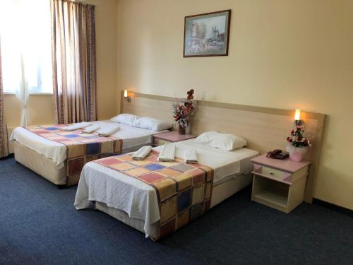 A bed or beds in a room at Akasia Resort Hotel