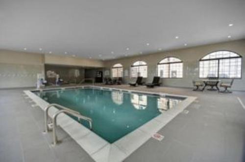 a large swimming pool in a large building at Staybridge Suites Dearborn, an IHG Hotel in Dearborn