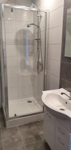 a bathroom with a shower and a sink at Apartamenty u Krysi 2 in Ząb