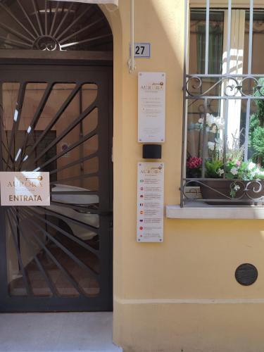 a door to a restaurant with a sign on it at Casa Aurora in Ravenna