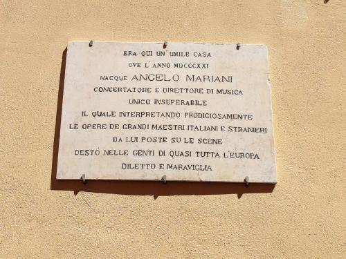 a sign on the side of a building at Casa Aurora in Ravenna