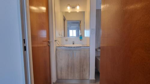 a bathroom with a sink and a mirror at Hermoso departamento, excelente ubicación. in Salta