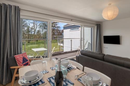 a living room with a couch and a table at Coedrath Park 20 - Modern Apartment, Close to the Beach in Saundersfoot