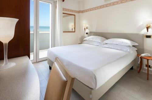 Postel nebo postele na pokoji v ubytování Hotel Bikini