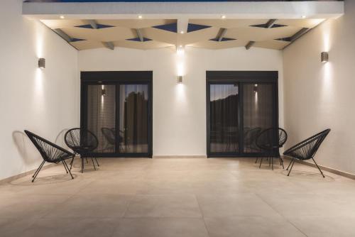 a room with black chairs and a ceiling at Villa De Reve in Laganas