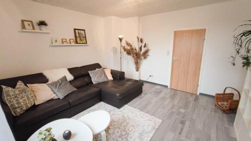 a living room with a couch and a table at Ferienwohnung zur alten Post in Bad Grund
