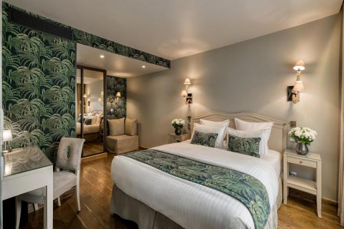a bedroom with a bed and a desk and a mirror at B Montmartre in Paris