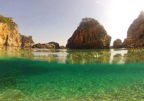 a view of a body of water with rocks at Boho Studios Liapades - Near restaurants, bus and beaches in Liapades