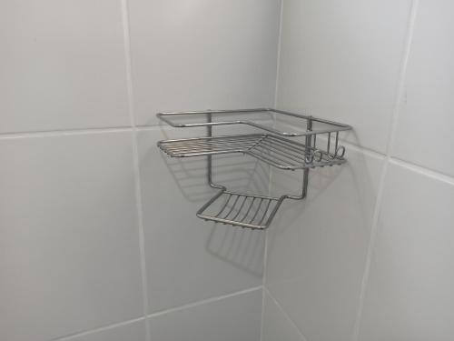 a glass shelf on the wall in a bathroom at Lord Hotel Camburi in Vitória