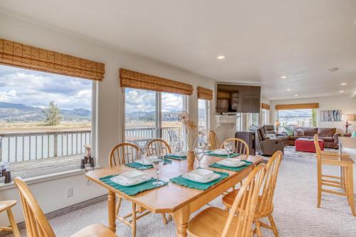 a dining room with a table and chairs with a view at Coastal River Haven - Meredith Lodging in Nehalem