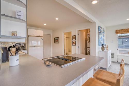 a kitchen with a counter top and a refrigerator at Coastal River Haven - Meredith Lodging in Nehalem