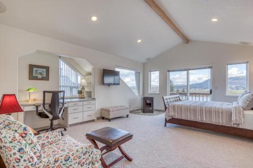 a bedroom with a bed and a desk and a couch at Coastal River Haven - Meredith Lodging in Nehalem