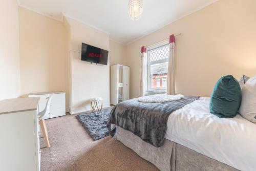 a bedroom with a bed and a window at *KING BED* LUXURY CITY CENTRE HOUSE in Barrow in Furness