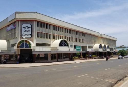 a large building on the side of a street at Swan Lakeview 2 Apartment with WiFi,Netflix Free Parking,Sunset,Lakeview in Kisumu