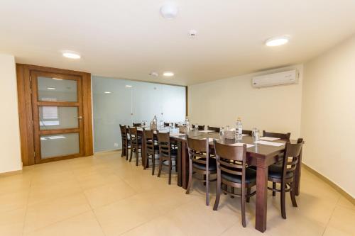 a conference room with a long table and chairs at The Seventh Star Hotel Suites in Amman