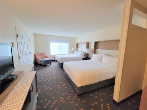 a hotel room with two beds and a flat screen tv at Holiday Inn Hotel & Suites Ann Arbor University of Michigan Area by IHG in Ann Arbor