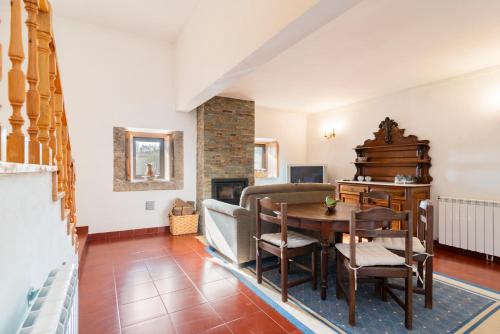 a living room with a table and a couch at Casa do Boco in Oliveira do Hospital