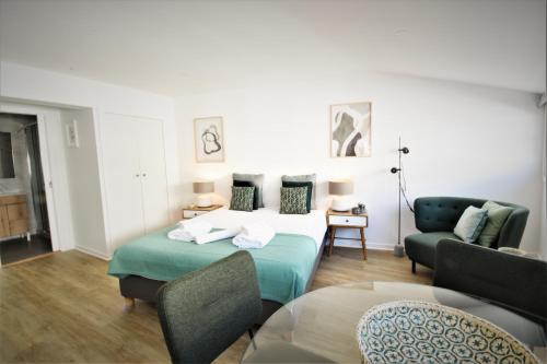 a living room with a bed and a couch at Sophia Studios in Coimbra
