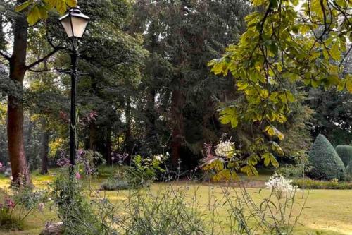 a park with a lamp post in the grass at Hayes Suite in Oswestry