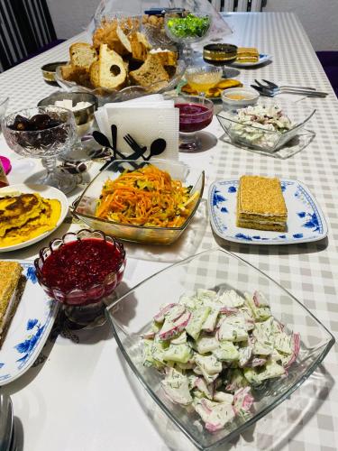 a table with many plates of food on it at Guest House KAGAN in Toktogul