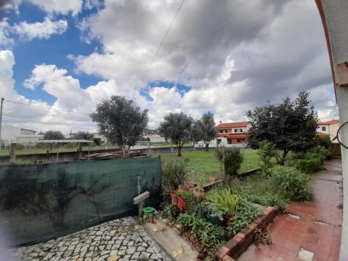 a view of a garden from a window at Mary's House in Cantanhede