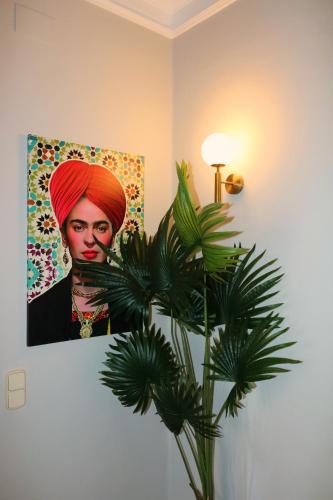 a painting of a woman with a red hijab and a plant at The Venue Hostel Boutique in Valencia