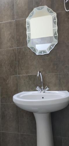 a white sink in a bathroom with a mirror at Majido Hotel in Wadi Musa