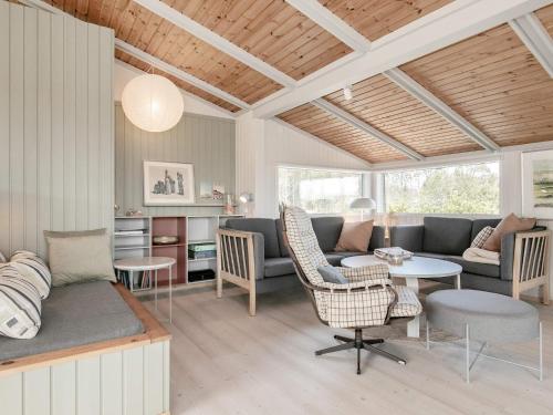 a living room with a couch and a table at 6 person holiday home in Ålbæk-By Traum in Ålbæk