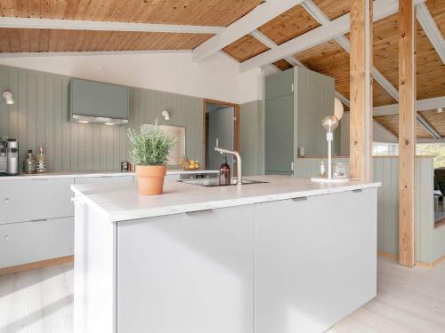 a kitchen with white cabinets and a sink at 6 person holiday home in Ålbæk-By Traum in Ålbæk