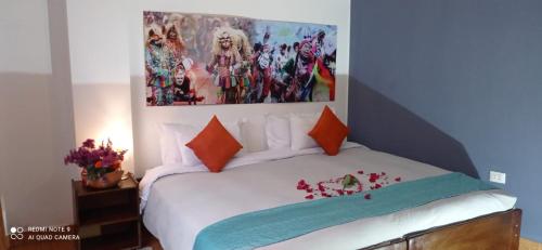 a bedroom with a bed with a painting on the wall at Runa Apartamentos in Cusco