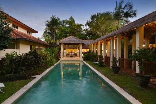 a swimming pool in the yard of a house at Seascape Holidays Villa 8 Surya in Port Douglas