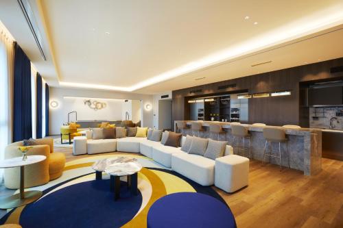a living room with couches and a bar at voco Seoul Gangnam by IHG in Seoul
