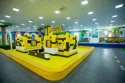 a lego house is on a yellow platform in a room at Hoang Hung Hotel in Dĩ An