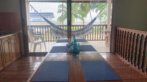 a table with a vase on top of it on a porch at Aloja-T en Casa de Playa Bahia Solano in Bahía Solano