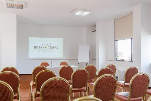 a conference room with chairs and a white table at International Bucharest City Centre Hotel in Bucharest