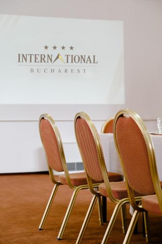 a table and four chairs in front of a table at International Bucharest City Centre Hotel in Bucharest