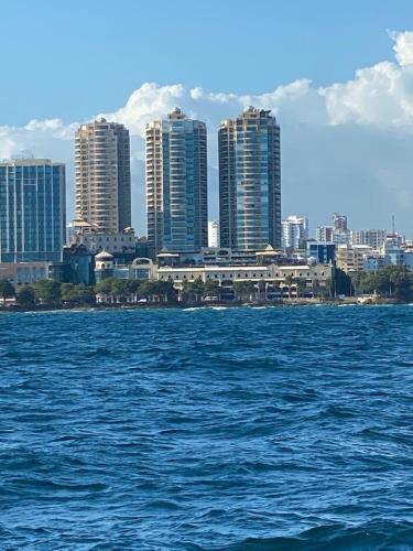 a view of a city from the water with buildings at Luxurious 2BDR condo located in Prestigious Tower. in Santo Domingo