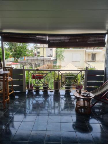 a view of a balcony with a table and chairs at CHEZ LILIANE in Saint-Denis