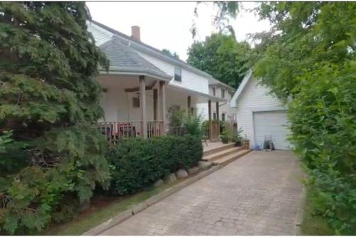 a house with a driveway and a garage at Garden 2 Storey House in Niagara Falls