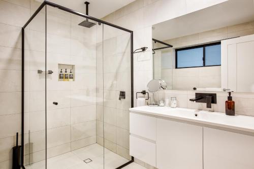a bathroom with a glass shower and a sink at Starboard Drift in Margaret River Town
