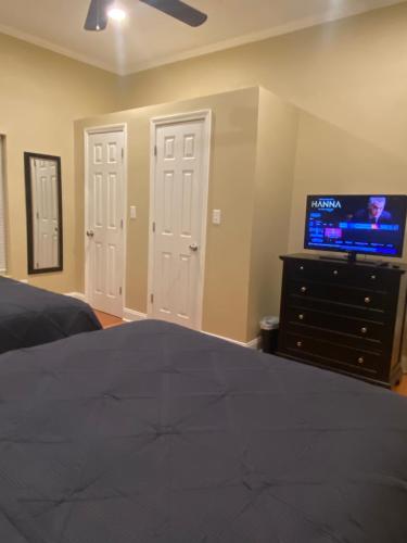 a bedroom with a bed and a tv on a dresser at Modern 3-bedroom, big fence yard, Pets stay free in Durham
