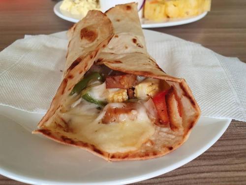 a slice of pizza on a plate on a table at Clare Holiday B&B in Checheng