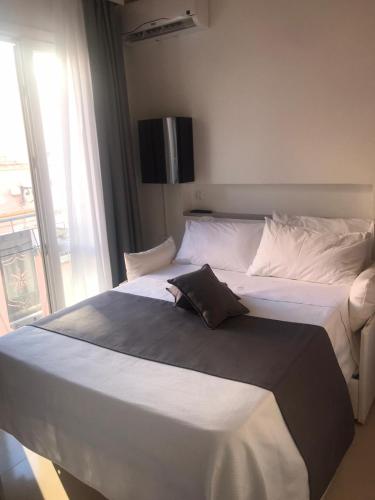 a bedroom with two beds with a television on the wall at Imera B&B in Favignana