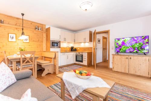 a living room with a couch and a dining room at Leitnerhof in Bad Reichenhall